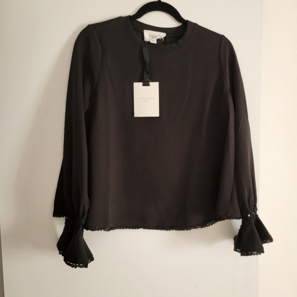 Pomander Place black top with detail around cuffs and bottom of top. Never worn.